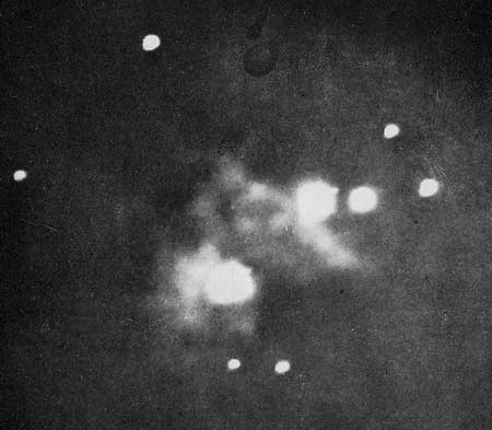 First photograph of the Nebula in Orion. Taken by Professor Henry Draper in 1880. The large stars, being much brighter than the nebula, are greatly overexposed.